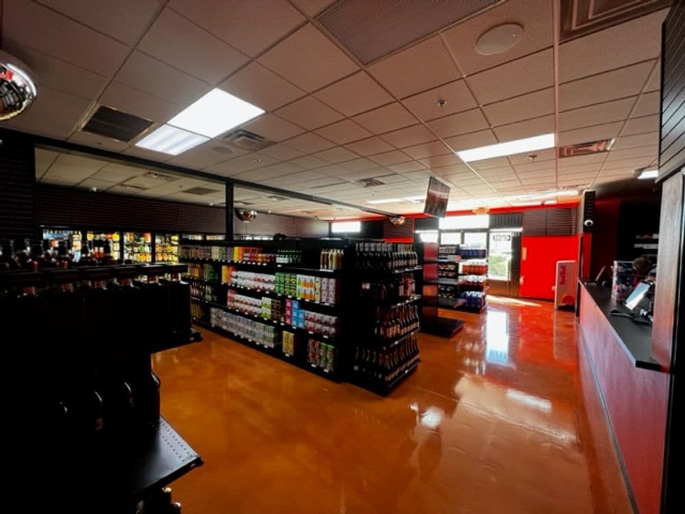 Interior view of a modern retail store showcasing organized shelves of beverages.